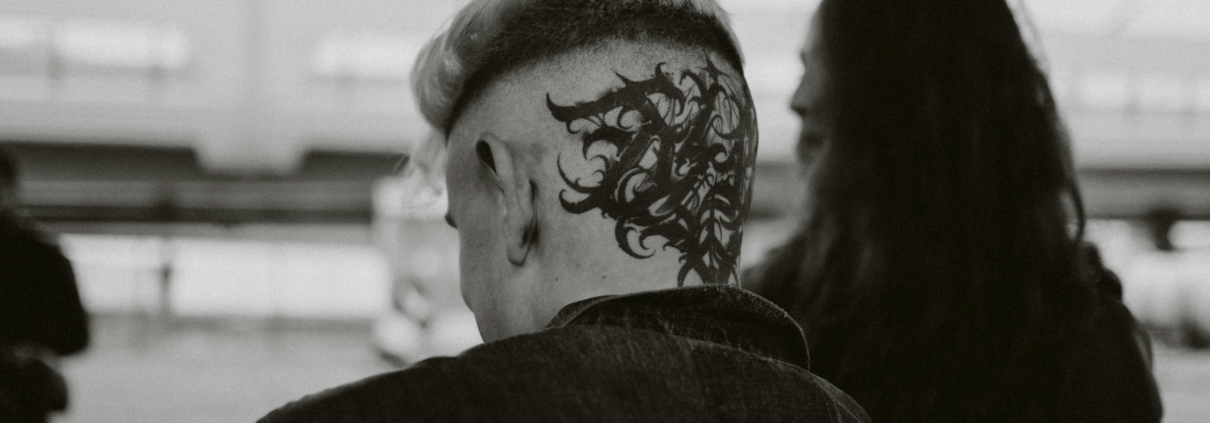 An intricate head tattoo on the back of a man's head.