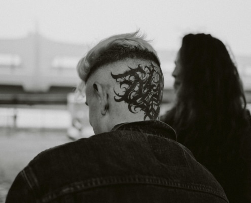 An intricate head tattoo on the back of a man's head.