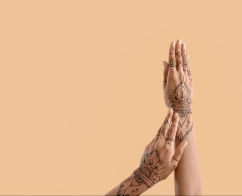 A beautifully intricate henna tattoo design applied on a hand.